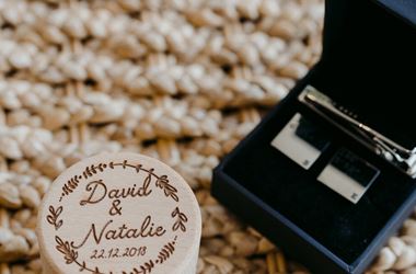 Natalie and David surrounded by greenery at rustic wedding