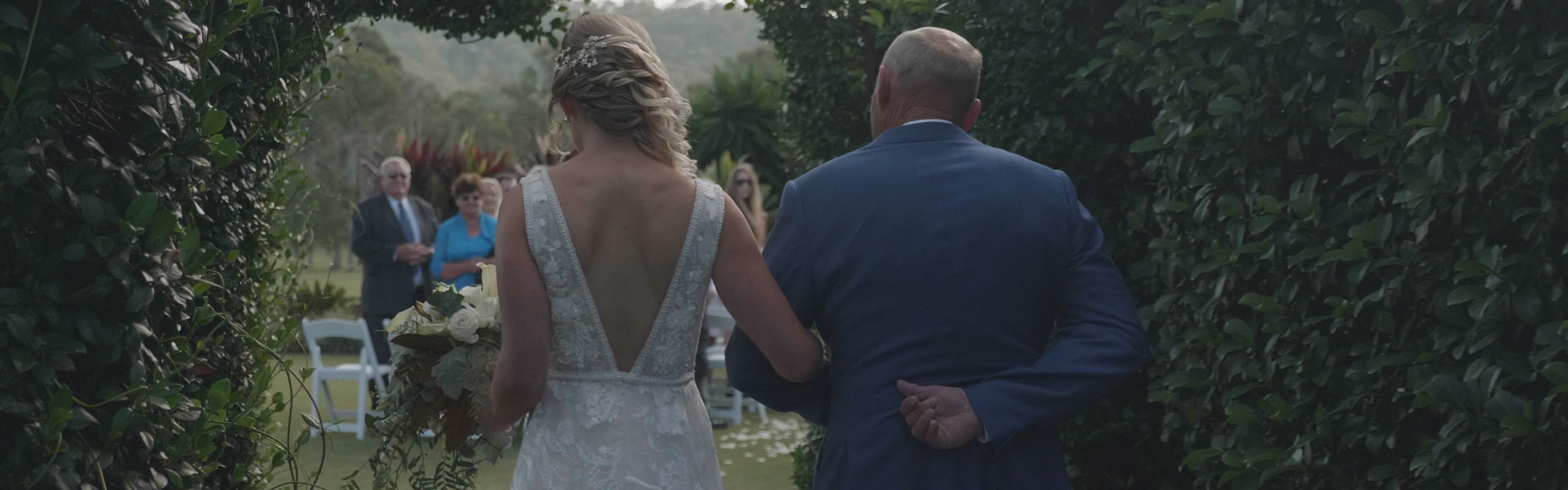 17ac9a9d-3869-4b36-87a1-7a8e10c7077a-Emily walks to ceremony.jpg