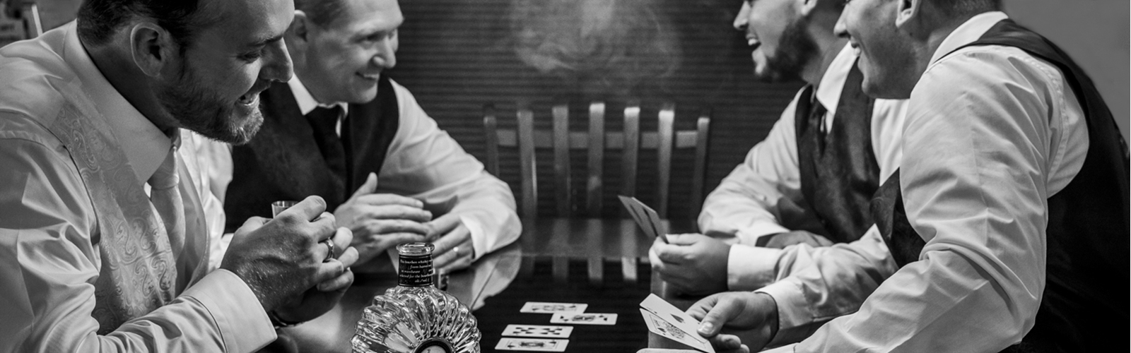 Groom with his groomsmen enjoying a game of cards.